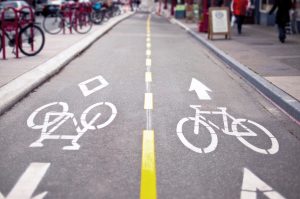 Painted bike lane markings showing bicycle symbols and directional arrows on a city street