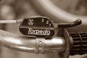 Bicycle handlebar and gear shift mechanism against a neutral background