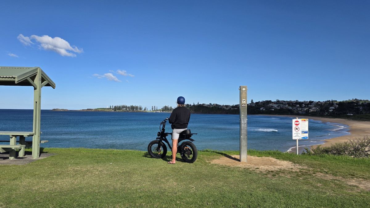 Cyclist enjoying the ocean views at Bombo Headland on the Kiama to Shellharbour ebike ride