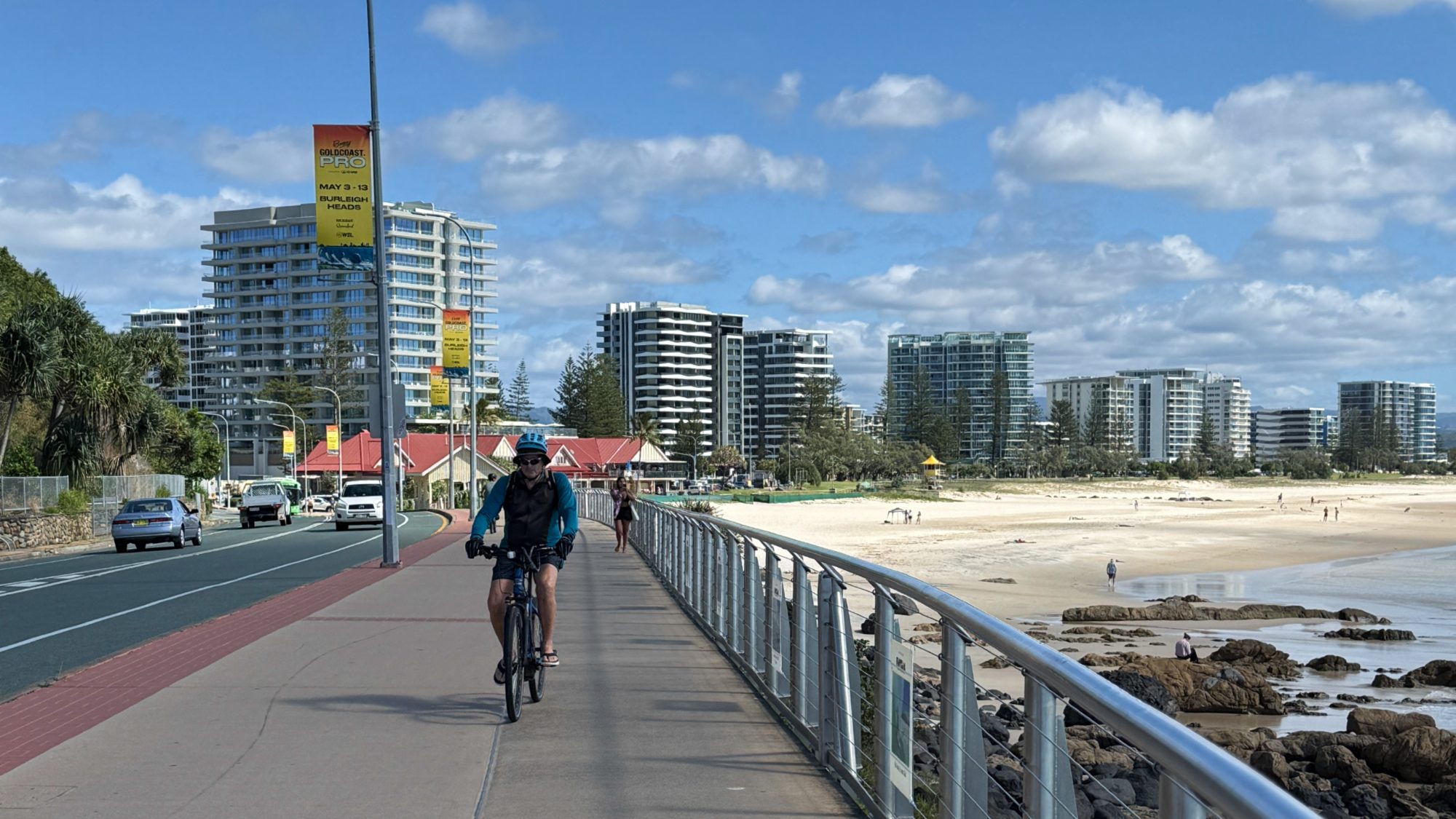 Cyclist riding the shared coastal path beside Kirra Beach on the Gold Coast