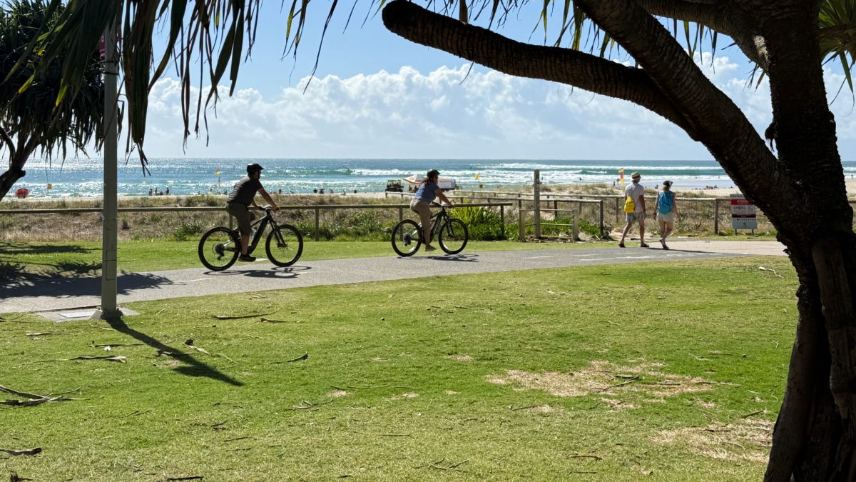 Cyclists riding beside the Gold Coast ocean